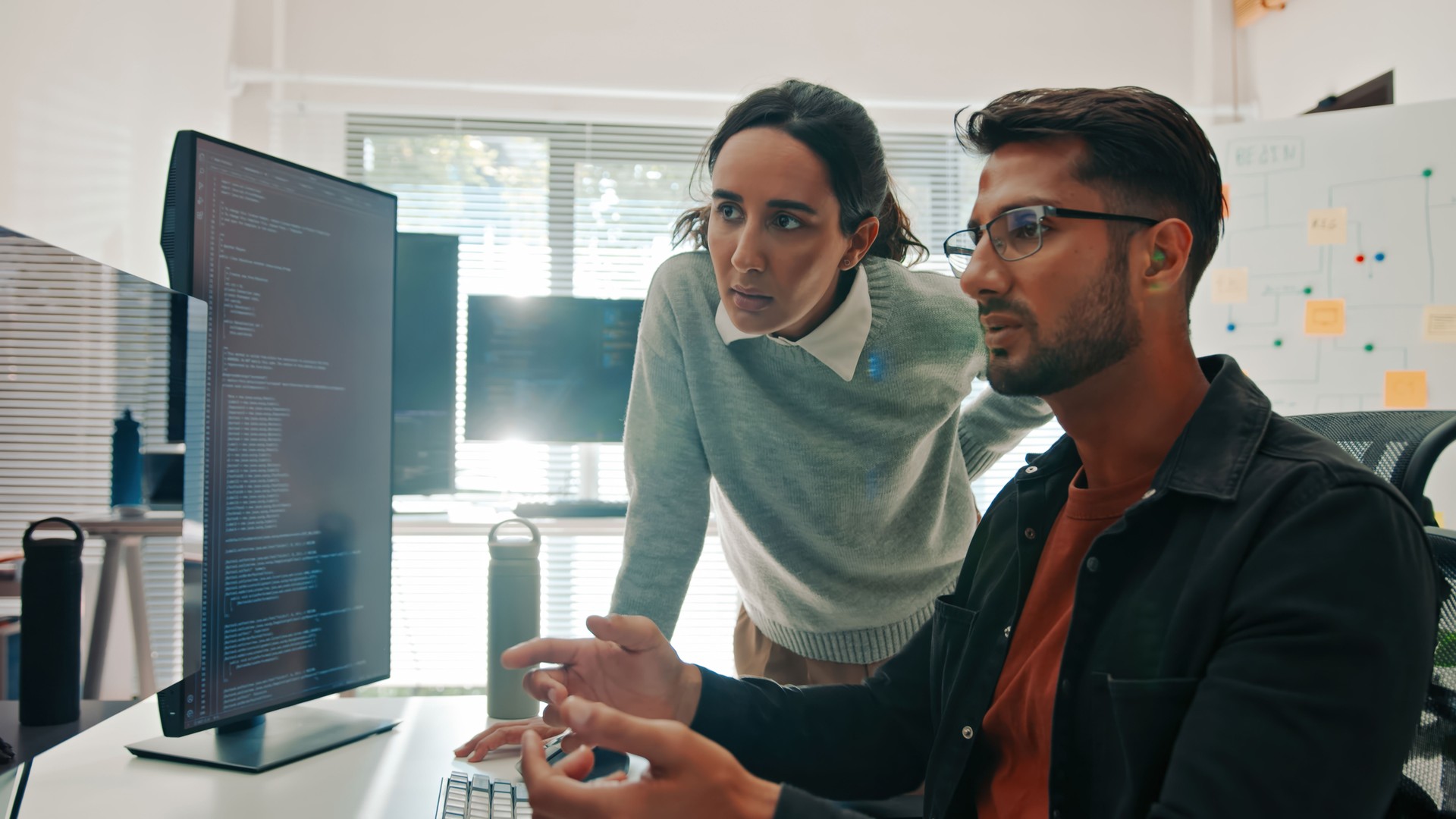 Hispanic Software Engineers Collaborating on Code